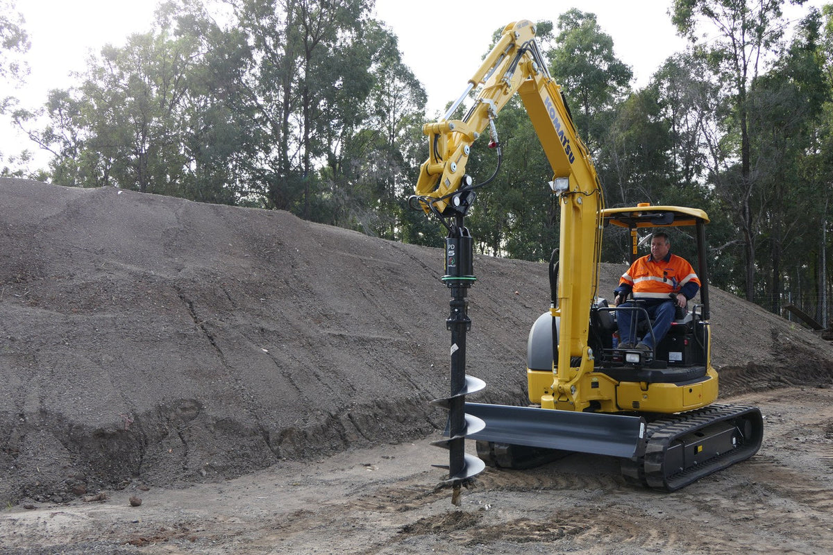 Excavator collaring a hole with a Digga auger drive