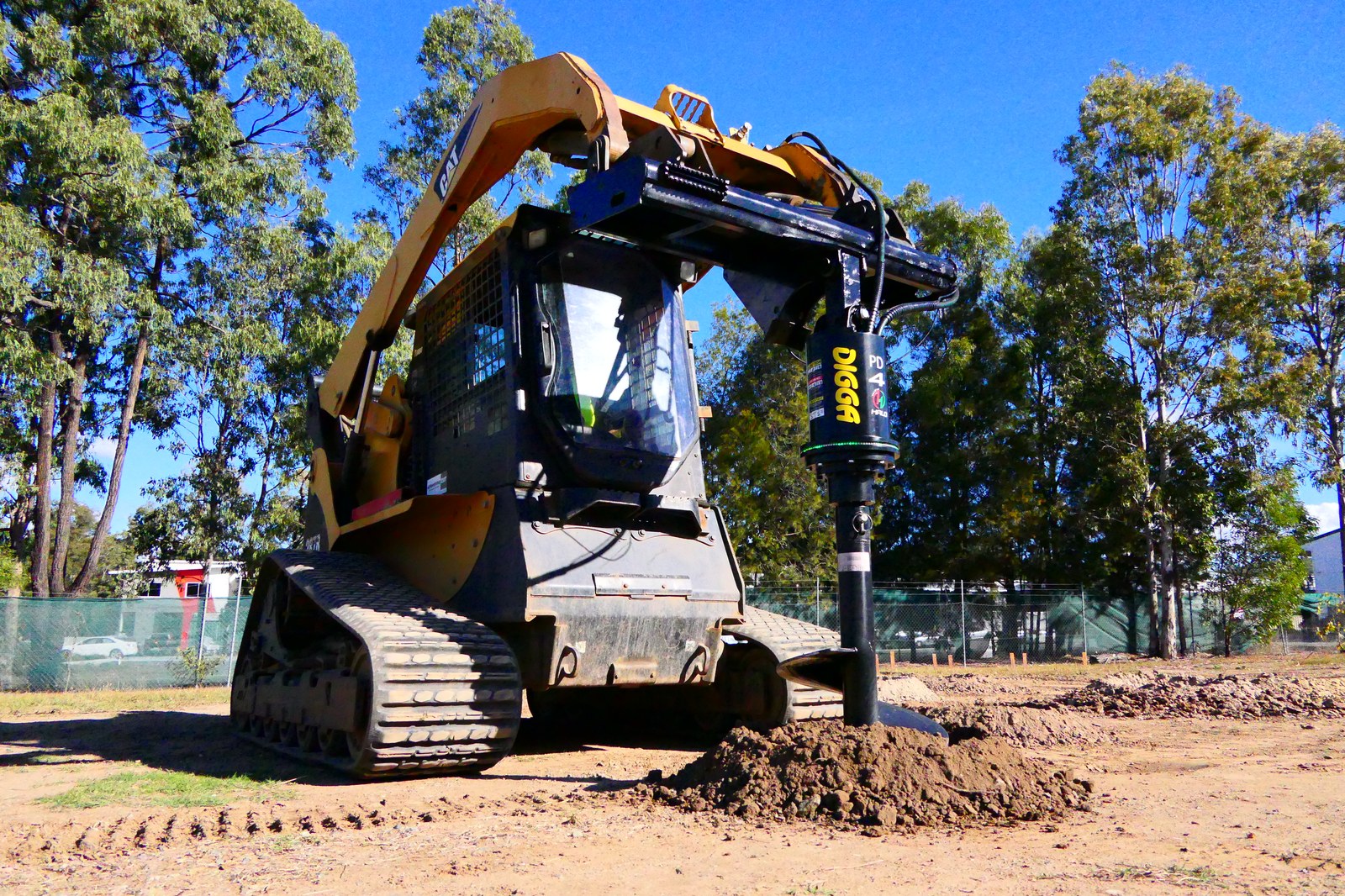 Compact track loader drilling with a Digga auger