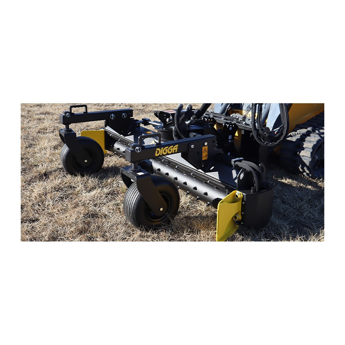 Digga power rake working behind a compact track loader